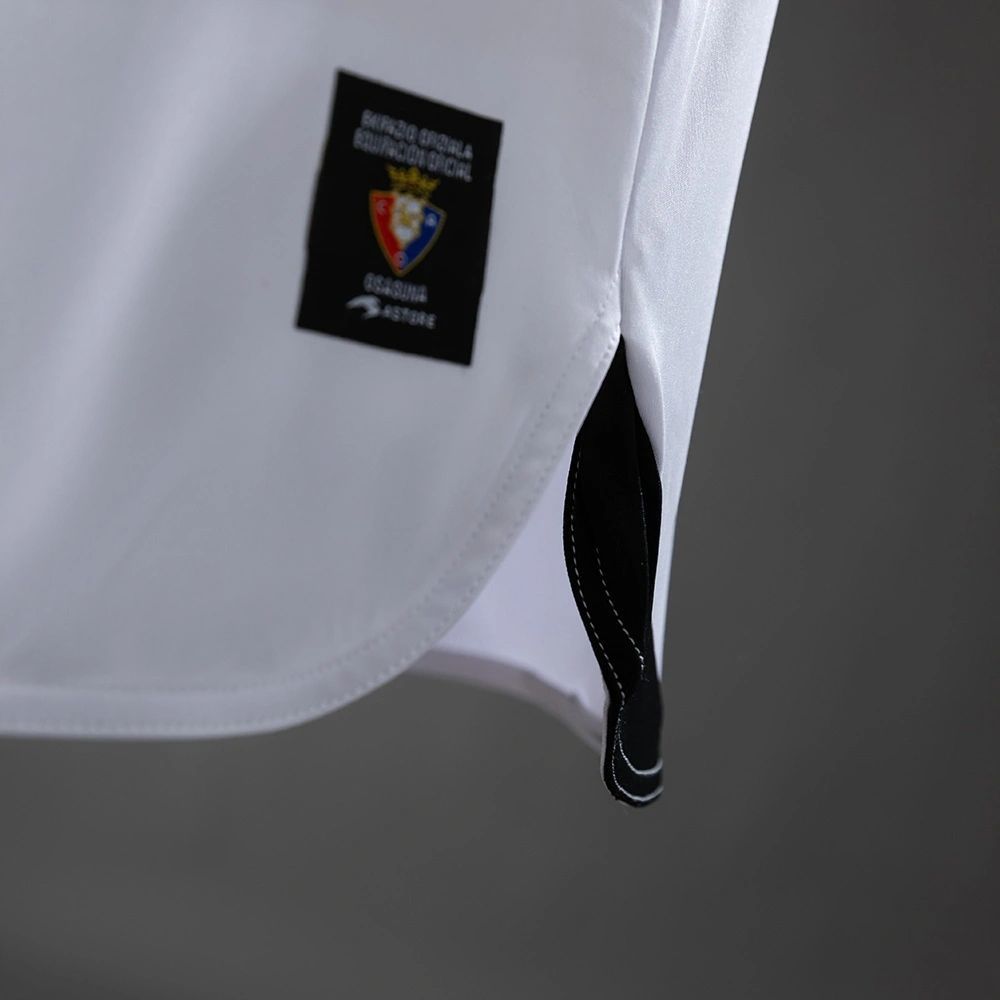 Side hem detail of the 2010-11 Osasuna away jersey showing stitching and authenticity label.