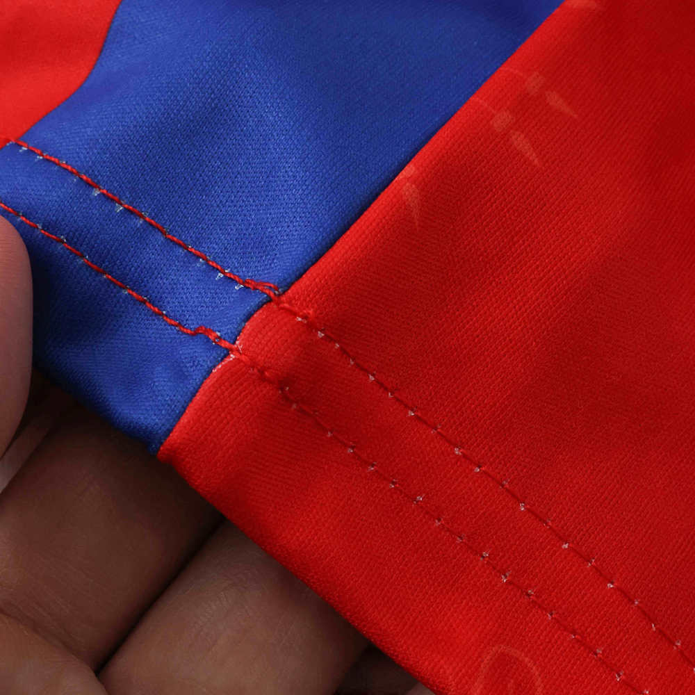 Detailed stitching at the side panel seam of the Haiti second away jersey, highlighting red and navy fabric connection.