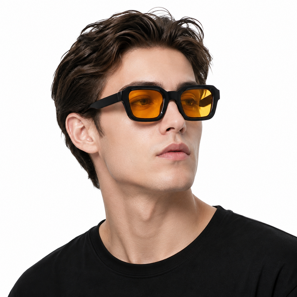 Model wearing black full-rim square sunglasses with amber lenses