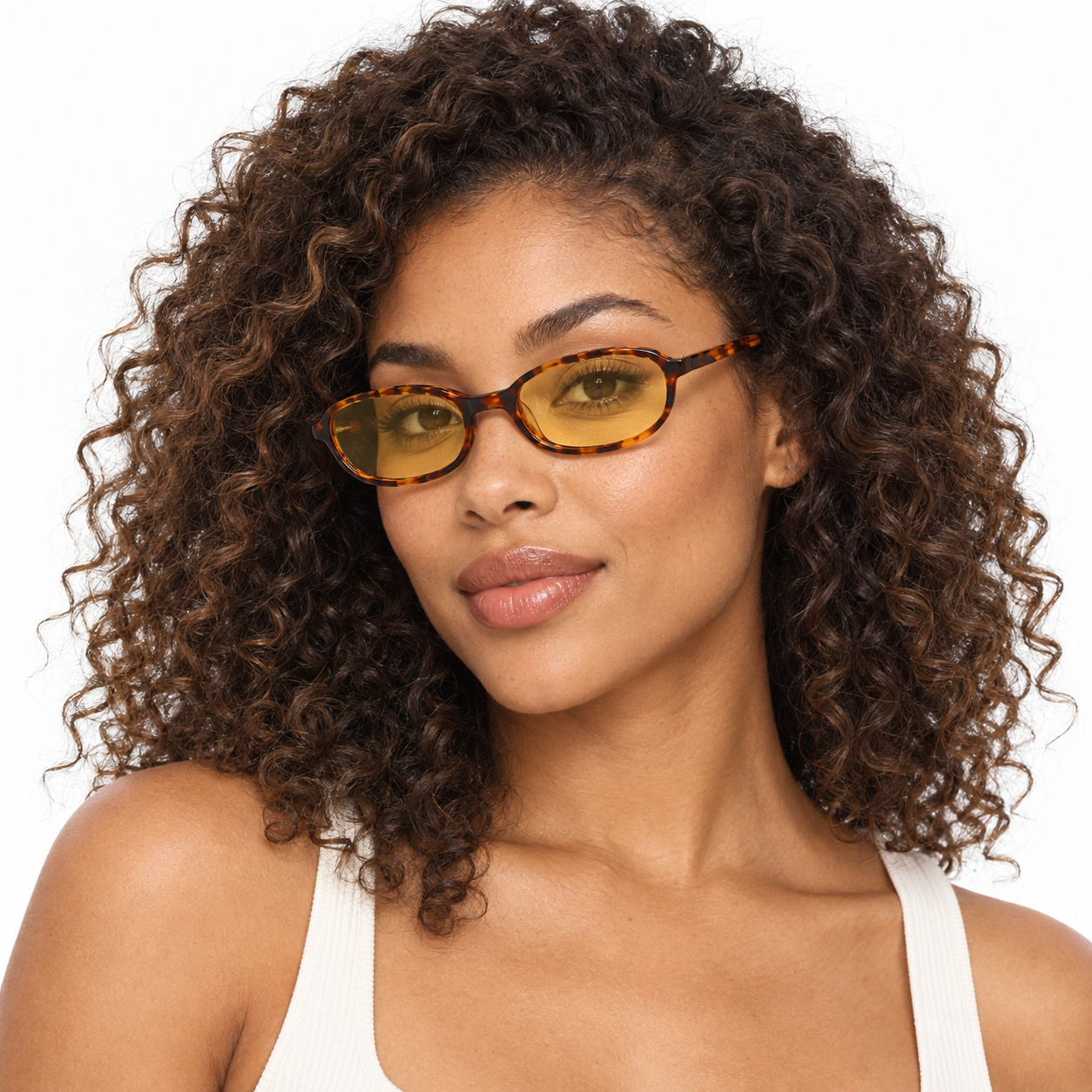 Tortoise full-rim small-frame oval sunglasses with yellow tinted lenses worn by a model