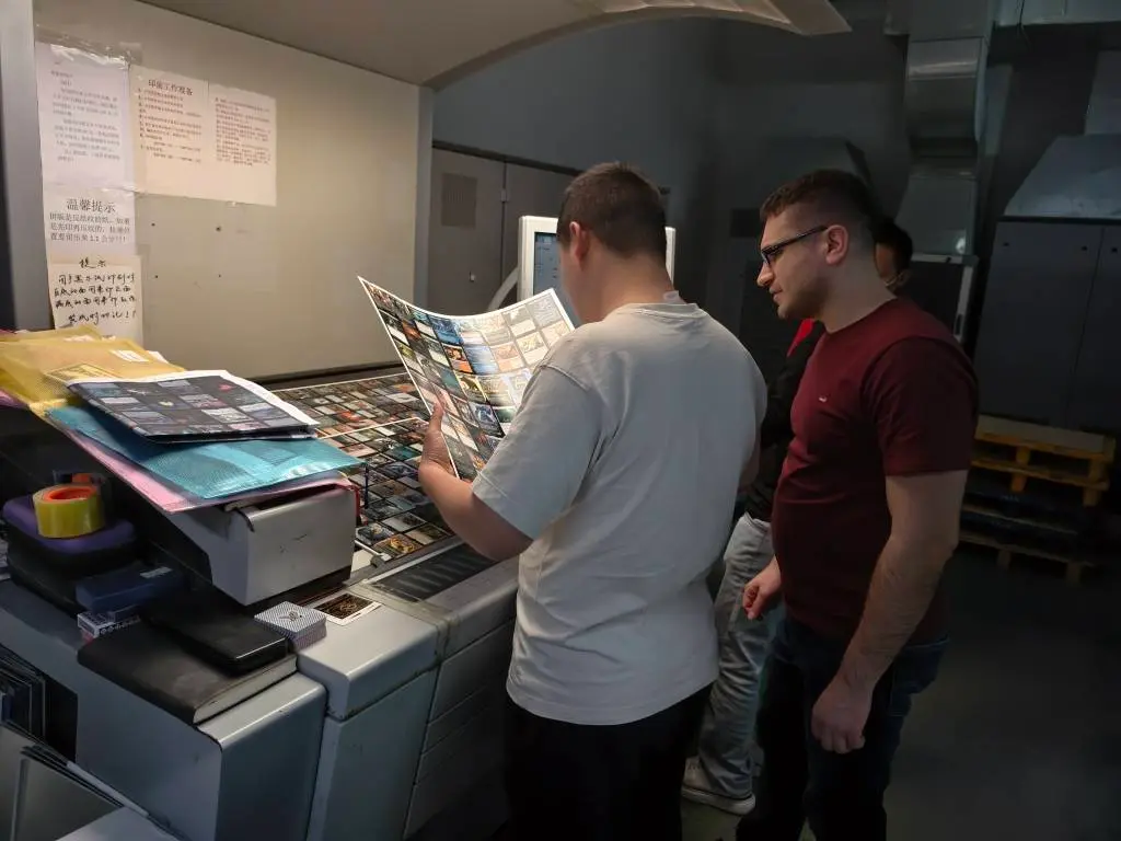 client reviewing custom card printing sheets during an on-press production inspection