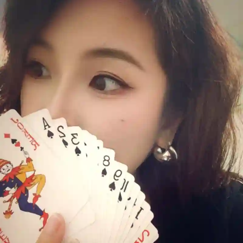 Ms. Maggie holding a fan of playing cards