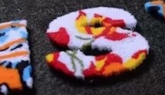 Toothbrush embroidery with upright thread texture